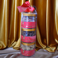 A three tier tower chocolate and confectionery gift pack from Chocamama with a red ribbon.
