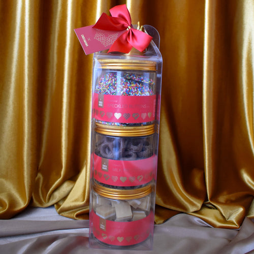 A three tier tower chocolate and confectionery gift pack from Chocamama with a red ribbon.
