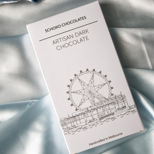 Block of artisan dark chocolate from Schoko Chocolates in white packaging with a black line drawing.