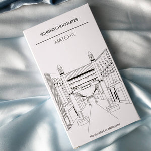 Block of matcha flavoured chocolate from Schoko Chocolates in white packaging with a black line drawing.