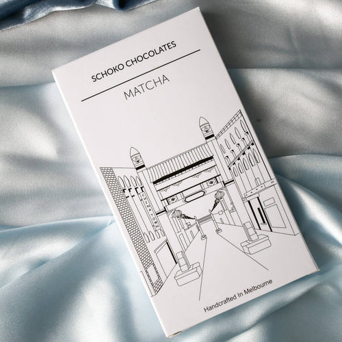 Block of matcha flavoured chocolate from Schoko Chocolates in white packaging with a black line drawing.